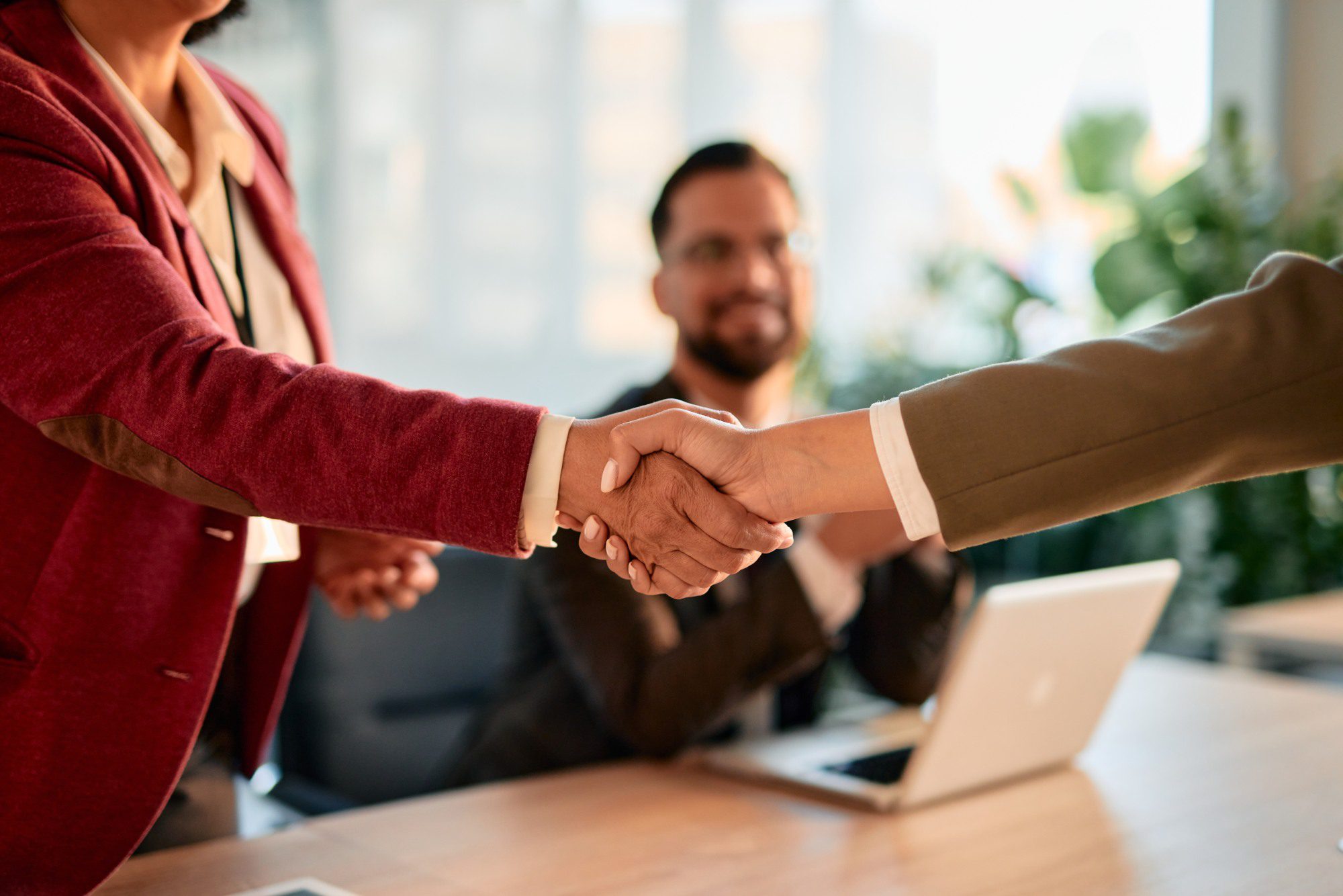 People shaking hands in a business meeting.